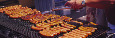 Man's Hand Cooking Hot Dogs on a Barbecue Grill, Taste of Chicago, Chicago, Illinois, USA